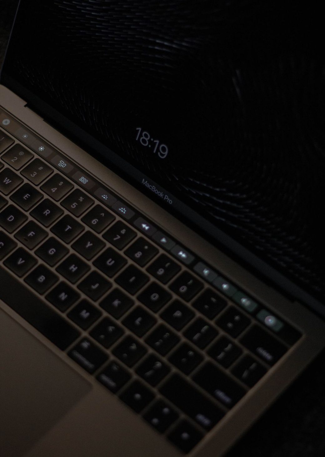 A laptop open in a dark room